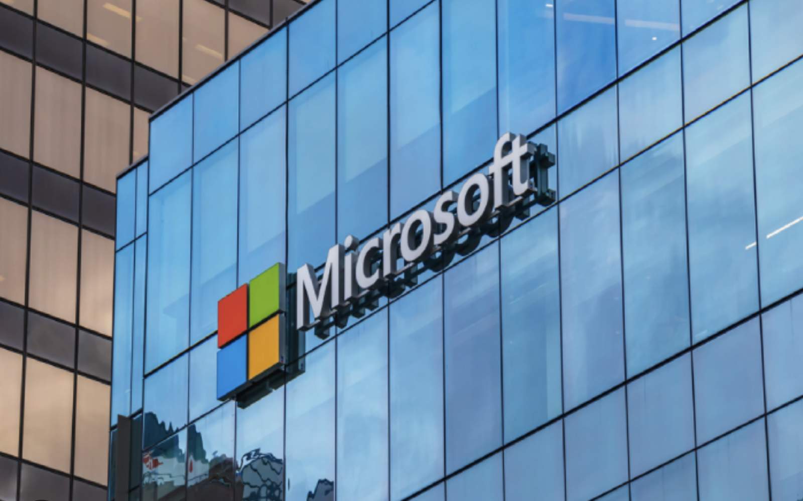 Microsoft corporate logo displayed on a digital screen representing cloud infrastructure and Microsoft stock analysis